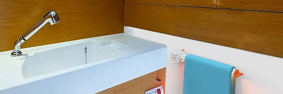 La barra riscaldante con una salvietta azzurra, accanto al lavabo nel bagno di una barca